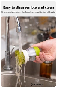Press-type kitchen cleaning brush with soap dispenser being rinsed under water