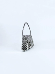 Detailed view of handcrafted silver beaded handbag with metallic beads and top handle