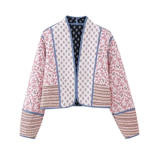Detail of bohemian quilted cotton jacket with floral prints and paisley patchwork