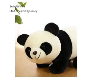 Close-up of a soft plush panda toy resting on a natural wooden surface with soft lighting