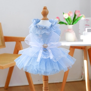 Detail of light blue pet dress featuring layered tulle and a large white organza bow