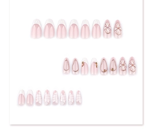 Macro detail of 3D floral almond press-on nails with gold accents and French design