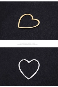 Detail of heart-shaped gold and silver jewelry connectors with side holes on leather