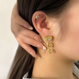 Textured 18K gold plated multi-layer heart earrings with zircon drop on model