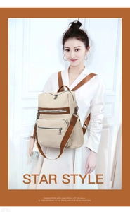 Detail of soft cream PU leather backpack with brown trim and stylish double zipper pockets