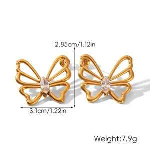 Detailed view of butterfly earrings in 18k gold finish with sparkling zircon inlay