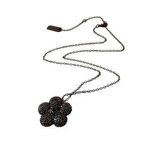 Gothic style necklace featuring a black flower pendant with sparkling crystals on a chain