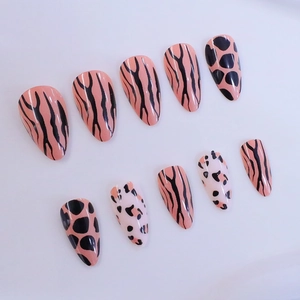 Short almond press-on nails with minimalist leopard and tiger animal print designs