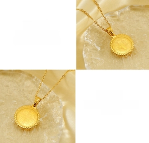 Macro detail of 18K gold plated titanium steel religious pendant with textured edge