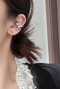Detailed close-up of a silver butterfly ear cuff with sparkling cubic zirconia on ear bone