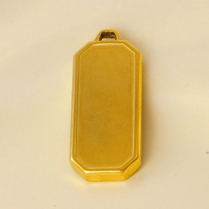Macro shot of minimalist gold rectangle pendant with a polished stainless steel finish
