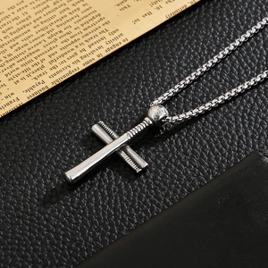 Detailed shot of silver stainless steel baseball bat cross pendant on box chain
