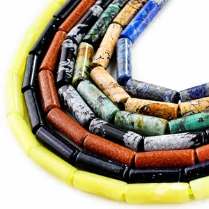 Detailed view of 3mm faceted natural stone beads in colorful cylindrical tube shapes