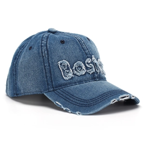 Detail of distressed Boston embroidery on a vintage washed denim baseball cap