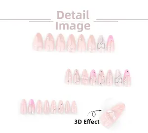 Detail of pink gradient press-on nails with 3D heart and silver metal accents