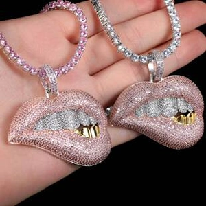 Detailed view of hip hop dripping lips pendant with pink rhinestones on a tennis chain
