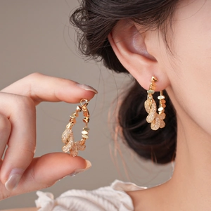 Golden geometric intertwined circular hoop earrings with micro-set zircon stones