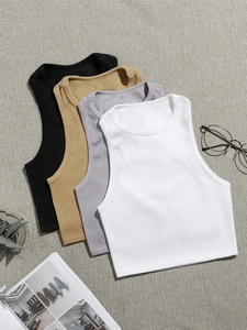 Detailed view of layered slim-fit ribbed yoga tanks in neutral colors on fabric