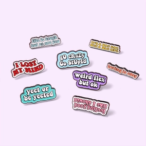 Set of 8 colorful enamel metal pins with inspirational English quotes on purple background