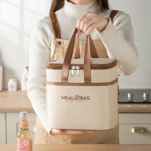 Beige insulated meal bag with durable handles and side mesh pocket for lunch box storage