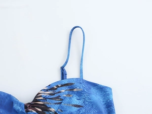 Close-up of blue floral print camisole top with thin spaghetti strap detail