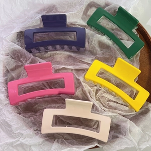Set of five large geometric cutout hair claws in purple, green, pink, yellow and cream