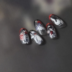 Close-up of Japanese style nail stickers featuring fox characters and red edge design