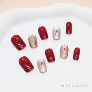 Faux ongles faits main œil de chat avec nœuds rouges et paillettes colorées forme carrée