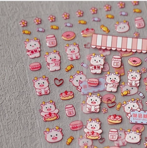 Close-up of 3D pink cartoon dragon nail stickers with cute dessert patterns and high gloss