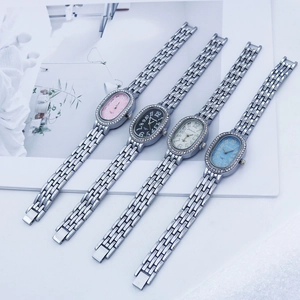 Detail showing four stylish oval quartz watches with diamond bezels and metal link bands