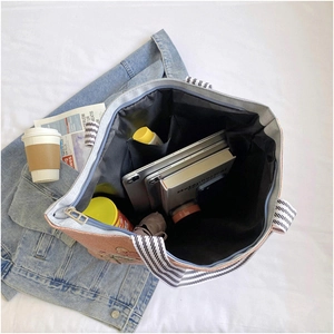 Top view showing large capacity of the pink canvas tote bag with striped straps