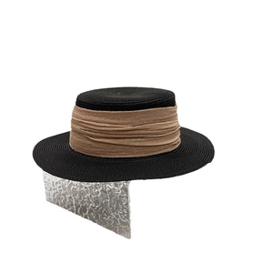 Elegant black boater straw hat with brown ribbon detail on a white background