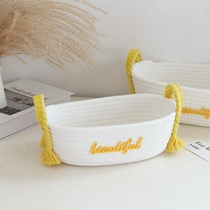 Detail showing white woven cotton storage basket with yellow tassels and beautiful text