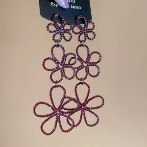 Detail of red rhinestone tiered floral tassel earrings with luxury hollow petal design
