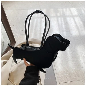 Detail of creative dachshund shaped shoulder bag in black leather with metal zipper
