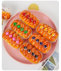 Set of 6 realistic faux cupcakes with colorful fruit toppings on a light pink plate