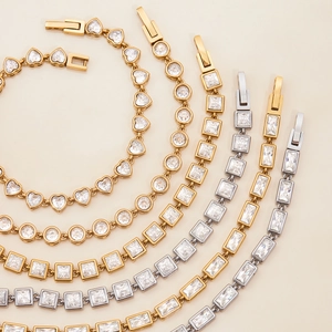 Macro detail of various gold and silver zircon bracelets in heart and geometric shapes