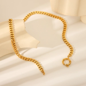 Close-up of gold stainless steel Cuban chain necklace with minimalist OT toggle clasp