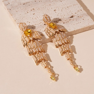 French vintage earrings with pearls, yellow gems and leaf structure on stone board