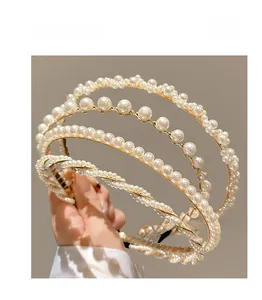 Close-up of elegant four-layer gold metal headband with white faux pearls for girls