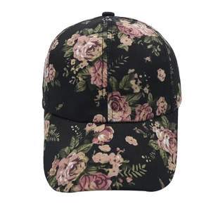 Detailed close-up of floral print patterns on a vintage black cotton baseball cap
