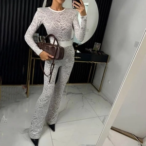 Chic white lace patchwork jumpsuit with long sleeves and wide belt for a stylish look
