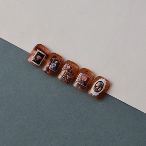 Macro detail of 5D embossed nail art stickers with vintage oil painting designs