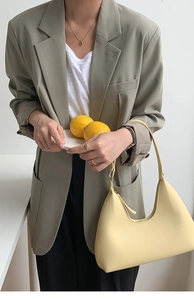 Pale yellow crescent underarm bag in smooth PU leather with silver metal hardware