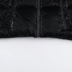Detail of high-gloss black water-resistant jacket with zipper and quilted seams