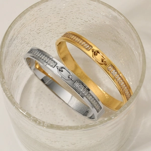 Luxe stainless steel bangle with baguette zircons in gold and silver finishes