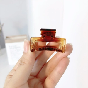 Close-up of tortoise shell pattern hair claw clip with amber translucent resin detail
