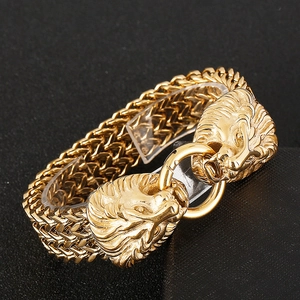 Macro shot of gold lion head clasp on braided metal chain bracelet for men