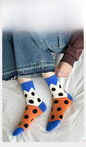 Detail of soft cotton crew socks with colorful polka dot patterns and elastic ribbed cuffs