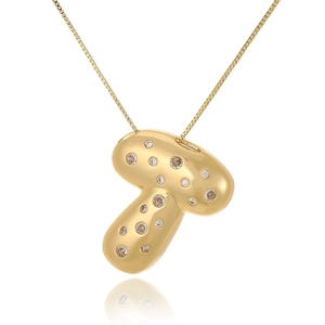Macro detail of a mushroom-shaped pendant with 18k gold plating and zircon inlay on box chain